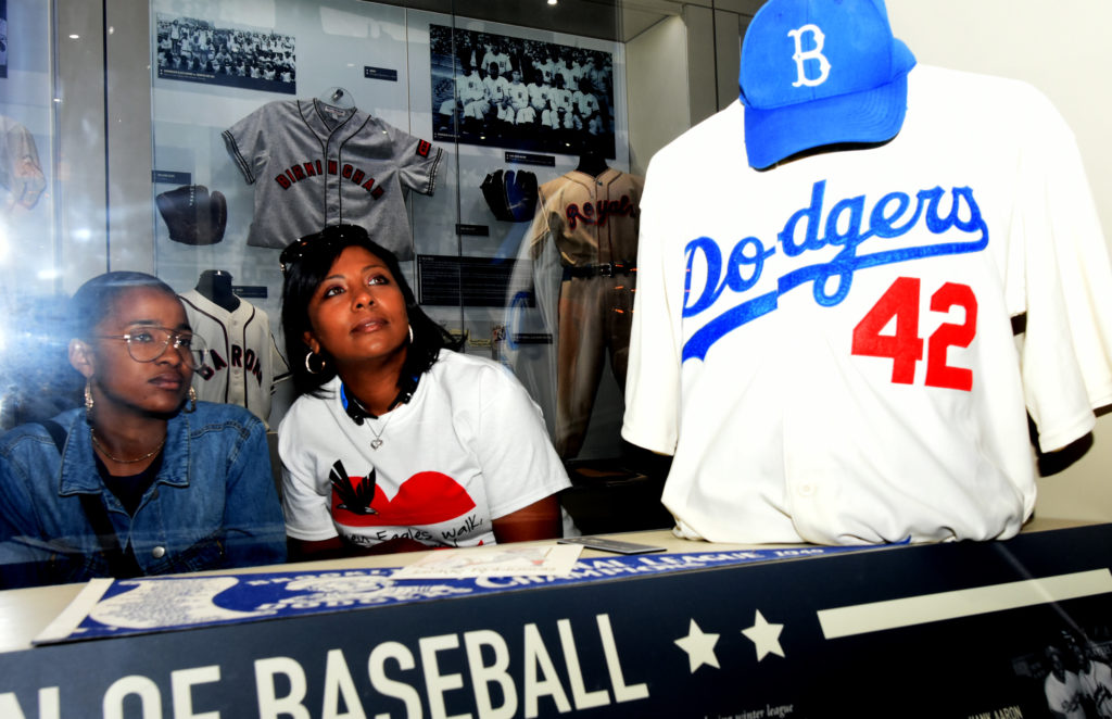 Chyna White, left, and her mother Charita Garcia-Jones look at the Jackie Robinson display at the Negro Southern League Museum. They were part of the 47-person Polk State College Upward Bound College tour group.