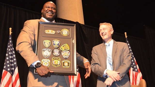 Shaquille O'Neal, left, poses with a gift from the Greater Alabama Council of the Boy Scouts of America, which Jeff Speegle presented to him. (Michael Tomberlin, Alabama NewsCenter)