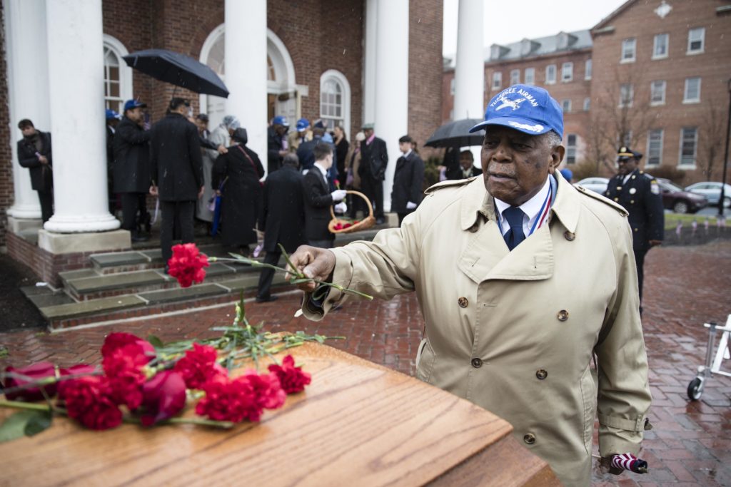 Tuskegee Airman Eugene J. Richardson Jr., places a flower on the casket containing the remains of his comrade John L. Harrison, Jr., after Harrison's a funeral mass at the Chapel of the Four Chaplains in Philadelphia, Friday, March 31, 2017.  Harrison Jr. became one of America's first black military airmen, one of nearly 1,000 pilots who trained as a segregated unit with the Army Air Forces at an airfield near Tuskegee, Ala. (Matt Rourke, Associated Press)