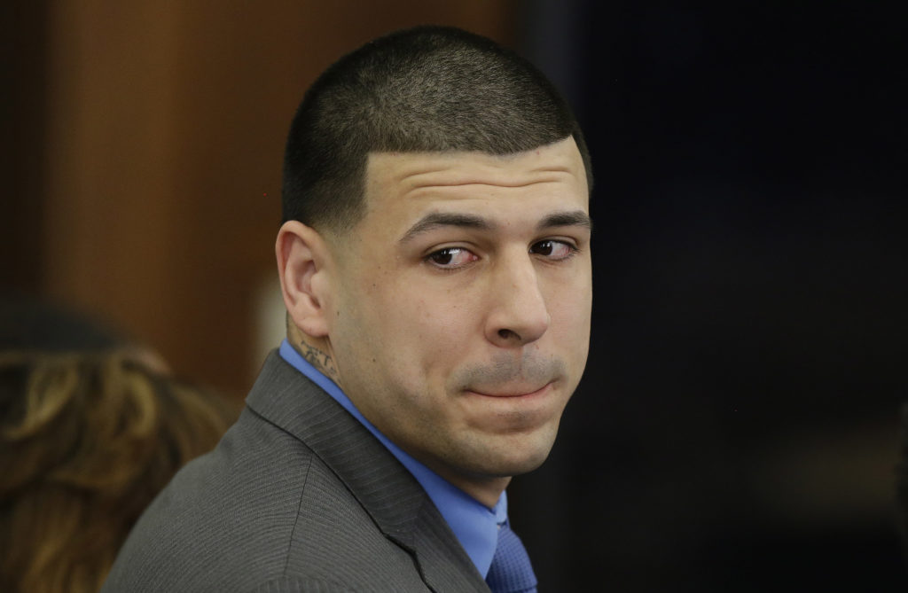 Former New England Patriots tight end Aaron Hernandez turns to look in the direction of the jury as he reacts to his double murder acquittal after the sixth day of jury deliberations at Suffolk Superior Court Friday, April 14, 2017 in Boston. Hernandez stood trial for the July 2012 killings of Daniel de Abreu and Safiro Furtado who he encountered in a Boston nightclub. The former NFL player is already serving a life sentence in the 2013 killing of semiprofessional football player Odin Lloyd. (AP Photo/Stephan Savoia, Pool)