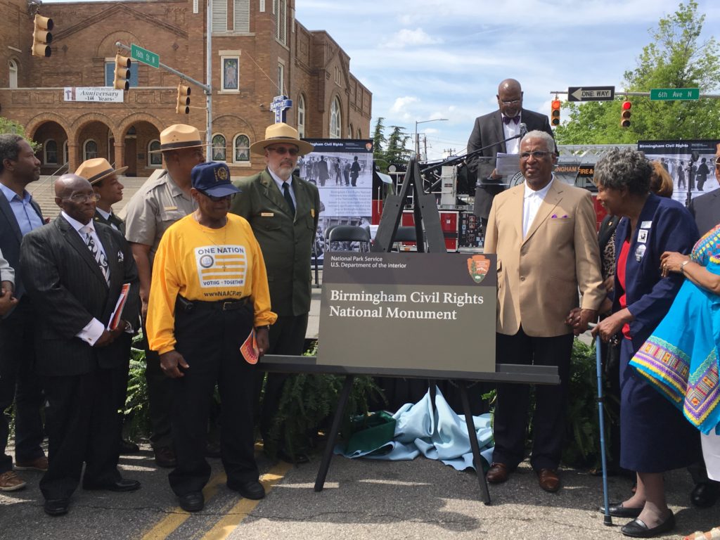 Bishop Calvin Woods (left) Mayor Bell (right) and footsoldiers of the Civil Rights Movement participate in the unveiling of the monument sign. (Monique Jones, The Birmingham Times)