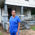 Theresa Butler in front of house where she grew up in Collegeville