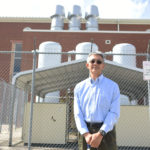 Dr. Z.T. Deng, an Alabama A&M mechanical engineering professor, poses with the outdoor parts of the school’s wind tunnel.