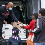 Damin Anderson passes lunches out to kids in the Elyton Village