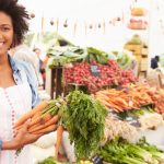 Female Stall Holder At Farmers Fresh Food Market