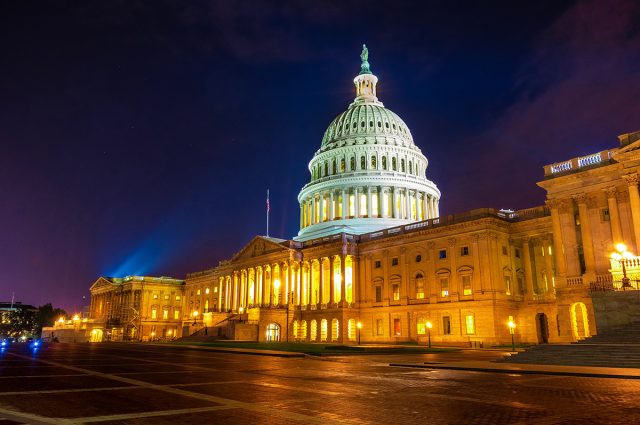 Spot light illuminates the domed marble United States Capital bu